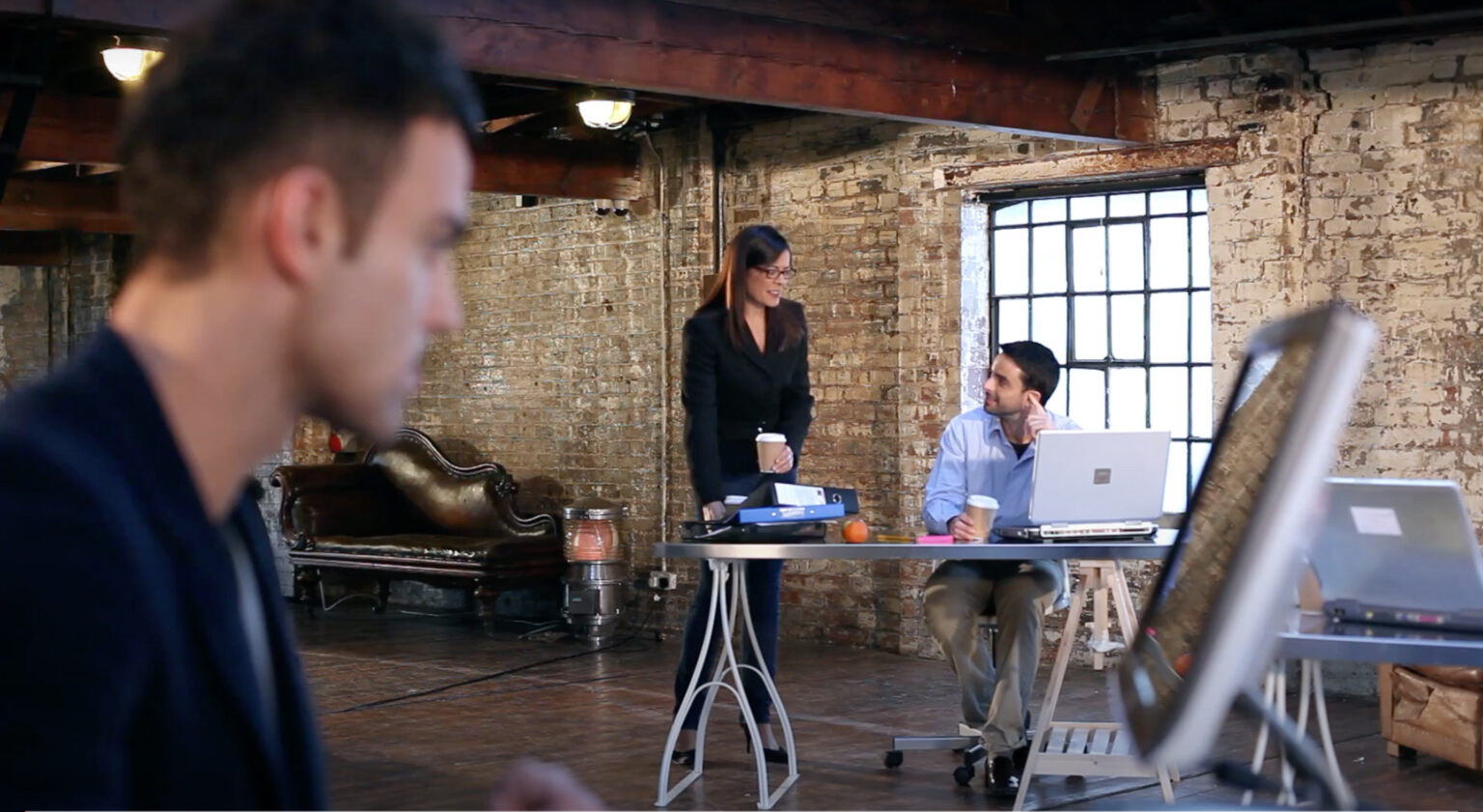 A sustainability marketing consultant shaking hands with a client in a bright modern office, illustrating why you want make real connections in person.