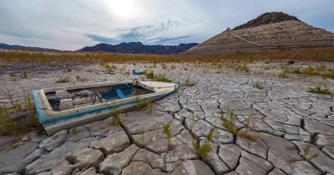A cracked, dry lakebed in the American West illustrates the growing reality drought that is reshaping water supplies across Colorado and neighboring states.